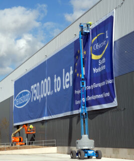large (wide) format promotional banner being hung